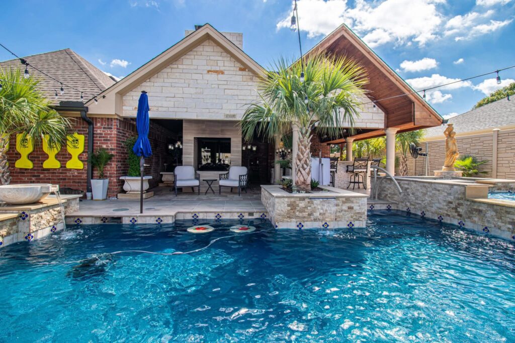 Outdoor kitchen next to pool and other water features